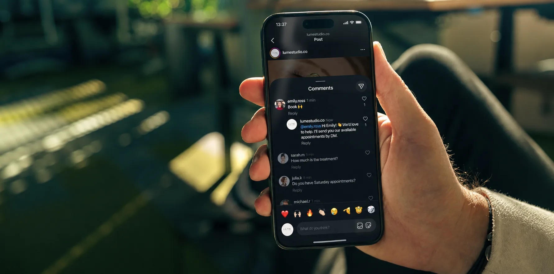 Photo from Chatfuel's Instagram comment autoreply page of a hand holding a phone showing an Instagram post's comments panel with replies under user comments